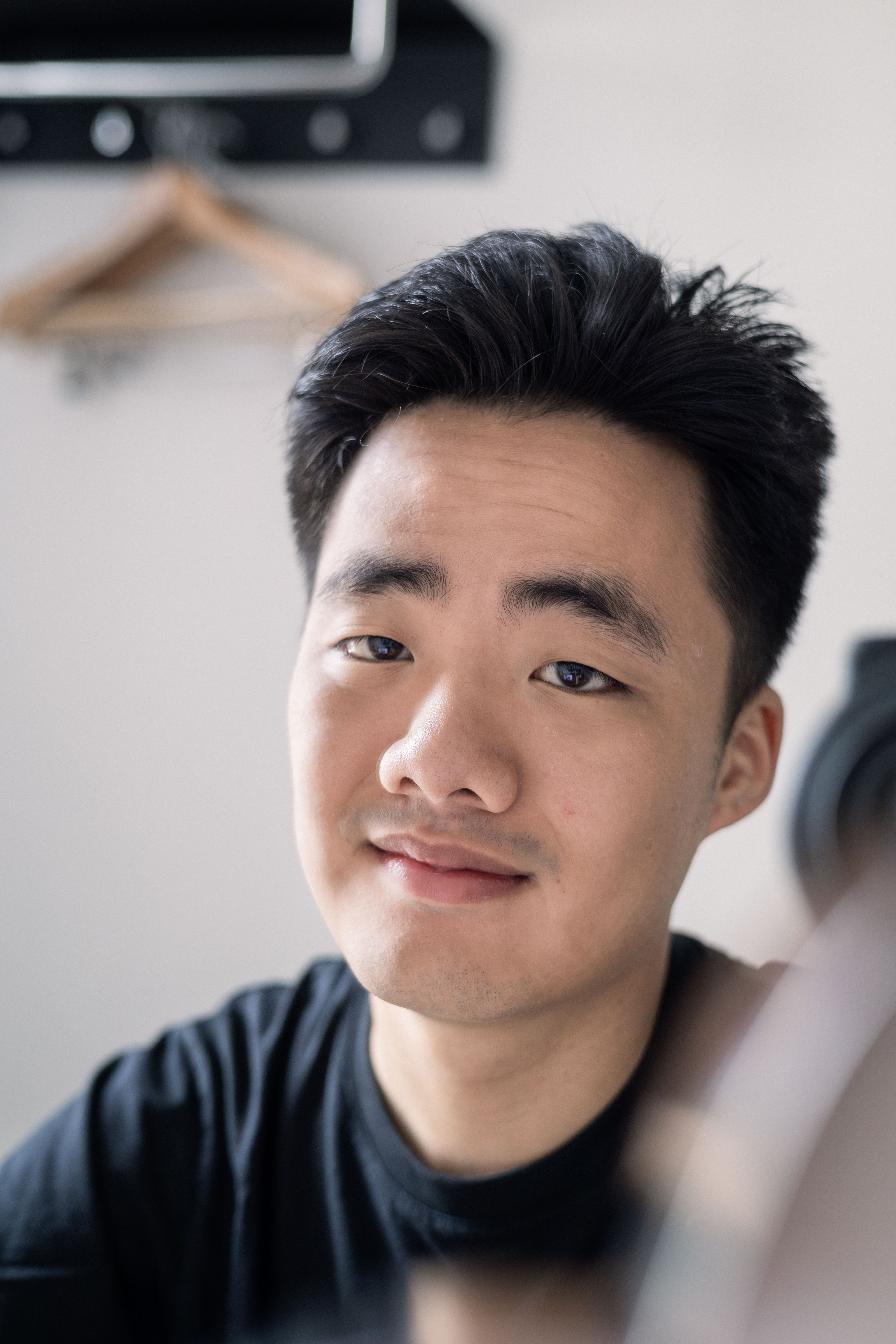 Self-portrait photograph of Eric Zhang at his desk